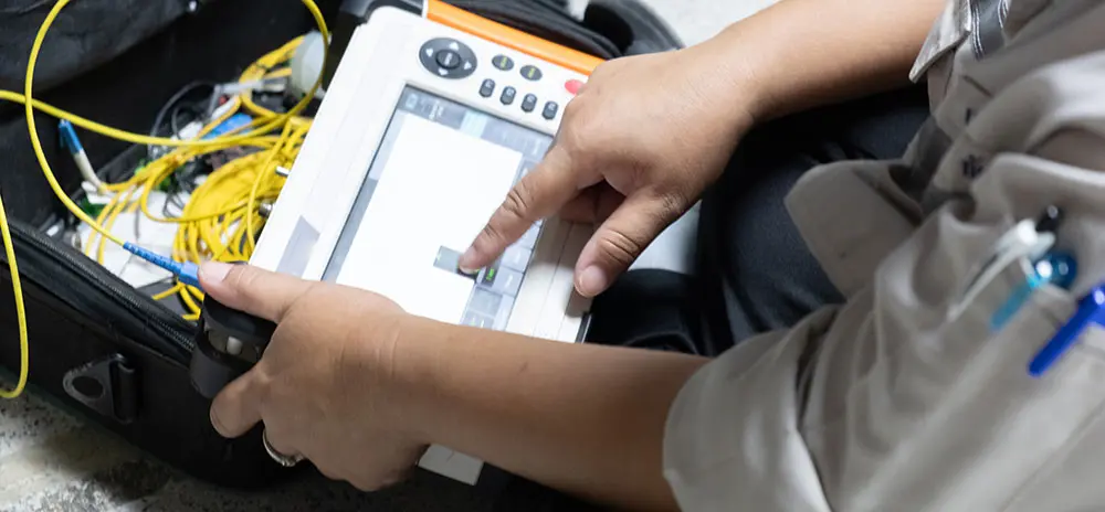 Technician performing testing and turnup on fiber internet
