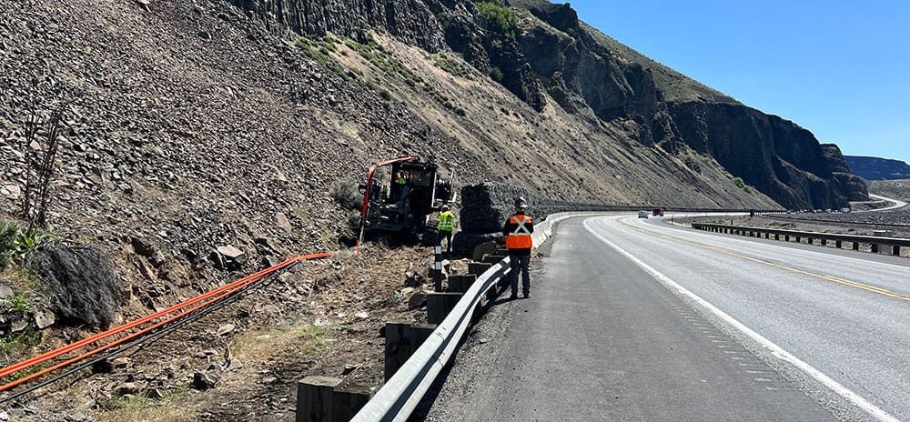 IIG crew installing fiber cable along a highway